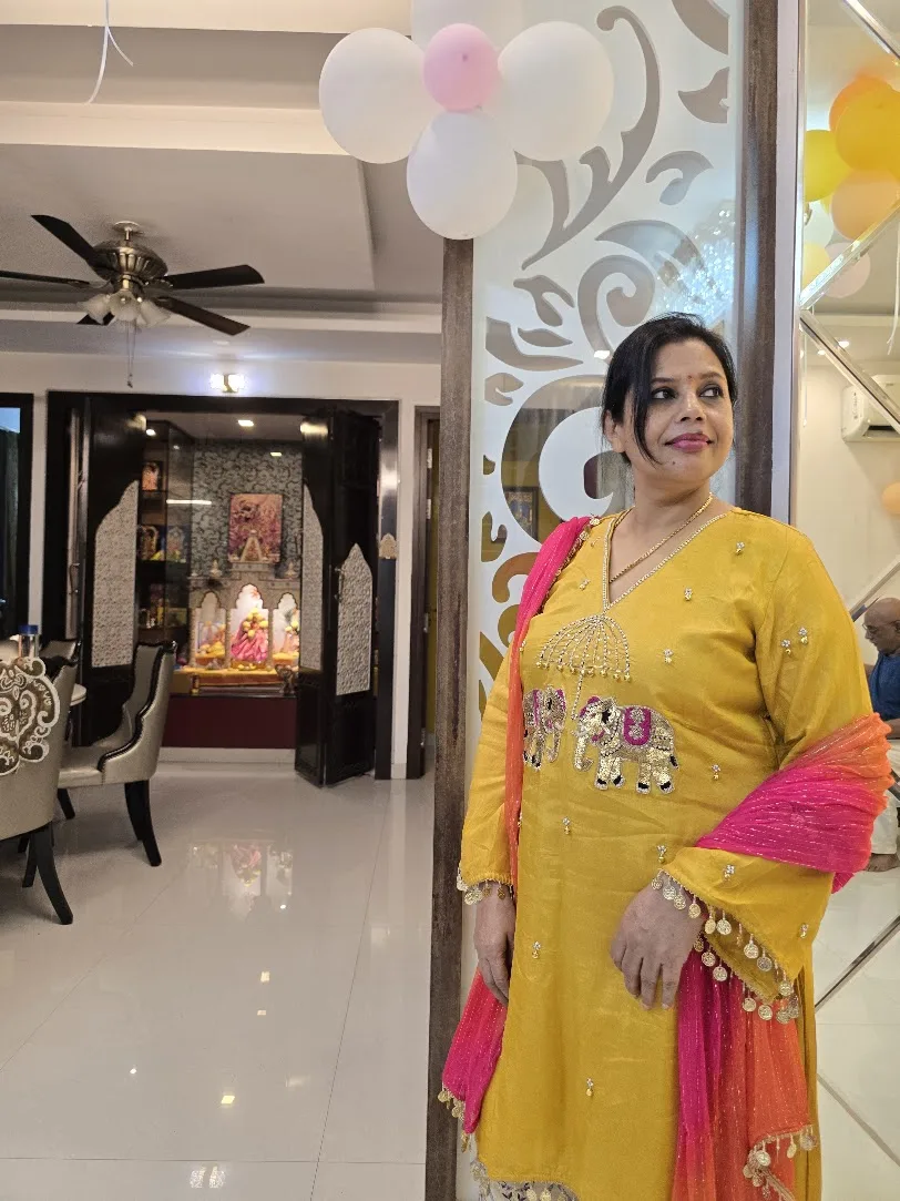 Seema in a yellow embroidered outfit at a family celebration